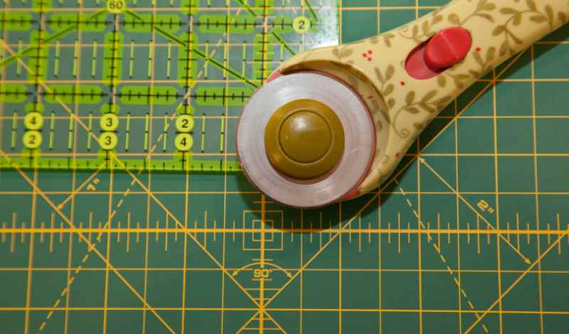 using a rotary cutter, cut excess fabric